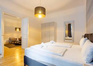 a bedroom with two beds and a living room at Exclusive Apartment City Center in Vienna