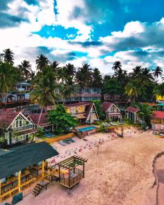an aerial view of a beach with palm trees and buildings at The Ark Comforts in Palolem