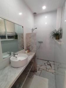 bagno bianco con lavandino e specchio di Lonos Circle Ocean View Room a Romblon