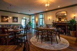 a restaurant with wooden tables and chairs and a mirror at The Northey Arms in Box