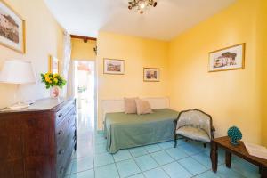 a bedroom with a bed and a desk and a chair at Mendolia Beach Hotel in Taormina