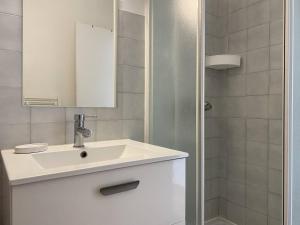 een witte badkamer met een wastafel en een douche bij Appartement à 200m de la mer à TREGASTEL PLAGES - Réf 744 in Trégastel