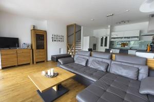 a living room with a couch and a table at Haus CKPK Lux in Sonnenalpe Nassfeld
