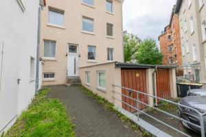 an alleyway between two buildings with a fence at Urban Retreat by stay awesome in Kassel