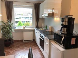a small kitchen with a sink and a window at 3 separate Messe Appartements bis zu 11 Personen in Ratingen