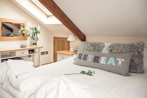 a bedroom with a white bed and a skylight at Duke House - Top Floor Apartment - 1 bedroom apartment with Hot Tub in Padstow