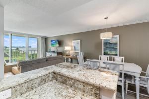 a living room with a couch and a table at Updated 2 Bed Condo Offering Long Beach Views From Balcony in Marco Island +16 photos