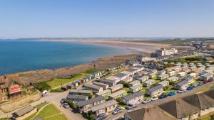 an aerial view of a row of houses next to the beach at 'Hartland Caravan' with Sea Views in Bideford