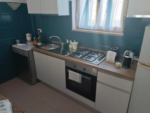 a small kitchen with a stove and a sink at Country House Gaeta in Gaeta