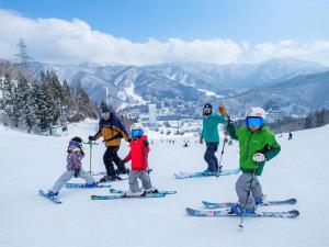 a group of people on skis in the snow at Naeba Prince Hotel in Yuzawa