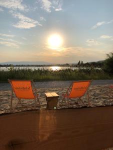 two chairs and a table on a sandy beach at Apartment Leuchtberg Flair Eschwege in Eschwege
