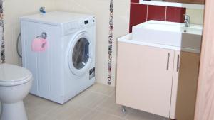 a bathroom with a washing machine and a sink at Park Ej's Lake View Apartment A73 in Ohrid