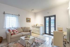 a living room with a couch and a table at Trulli Garden Harmony by Rentbeat in Martina Franca
