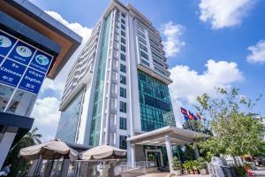 a tall building with umbrellas in front of it at ANINA Office & Serviced Apartments in Phnom Penh
