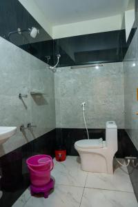 a bathroom with a pink toilet and a sink at HOTEL NNP GRAND Rameswaram in Rāmeswaram