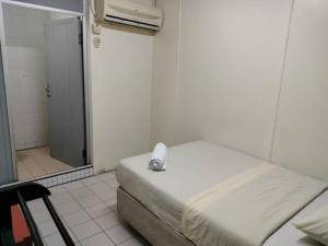 a hospital room with a bed and a shower at Grand Heritage Hotel in Melaka