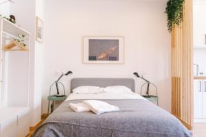 a bedroom with a bed with two pillows on it at Porto serenity studio in Porto