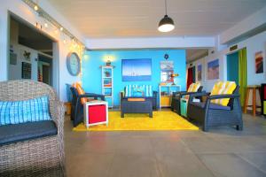 a childrens play room with blue walls and chairs at The Waves Hostel in São Vicente