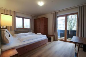 a bedroom with a large bed and a large window at Hochtenn Lodge in Zell am See - Steinbock Lodges in Zell am See