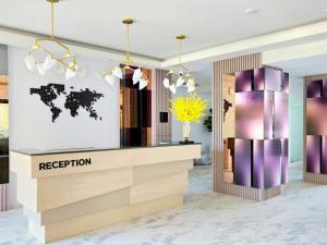 a lobby with a reception desk with a map of the world at Sand Dance Hotel in Prachuap Khiri Khan