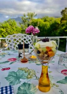 a table with a glass vase with a dessert in it at The View Swellendam B&B in Swellendam