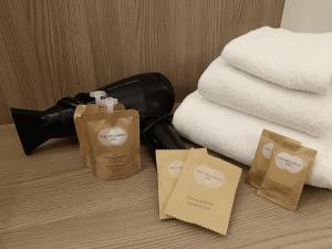 uma pilha de toalhas e sacos de papel numa cama em A Nanein con Joy em Bolonha