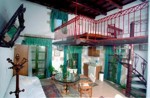 een woonkamer met een trap en een glazen tafel bij IFIGENIA TRAD.ROOMS IN OLDTOWN BY.MARIOS in Chania