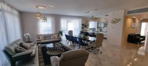 a living room with a table and a dining room at JTower Royal Suites - Alefimmoed in Jerusalem
