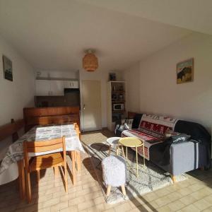 a living room with a couch and a table at Appartement T2 30m2 Vielle Aure in Vielle-Aure