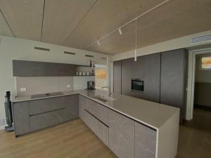a large kitchen with a sink and a counter at Infinity Villa Salò in Salò
