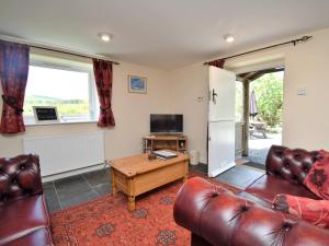 a living room with a couch and a table at 2 Bed in Rhayader 45387 in Llangurig