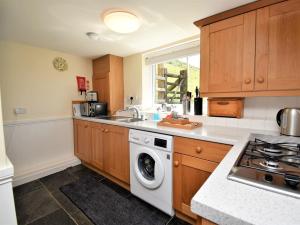 a kitchen with a washer and dryer in it at 2 Bed in Rhayader 45387 in Llangurig