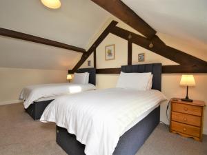 two beds in a room with a roof at 2 Bed in Rhayader 45387 in Llangurig