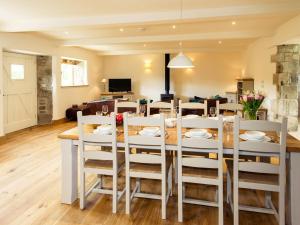 a dining room and living room with a table and chairs at 3 Bed in Melbury Abbas 48804 in Melbury Abbas