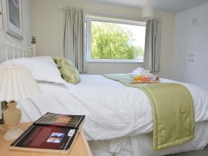 a bedroom with a white bed with a window at 4 Bed in Thirsk 49481 in Thirsk