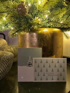 a christmas tree in a gold vase with a card at BergSoul in Garmisch-Partenkirchen