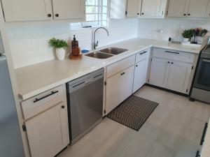 a kitchen with white cabinets and a sink at The Lane Rodney Bay 1 bedroom rate - Newly renovated & tastefully furnished 3 bedroom house home in Rodney Bay Village