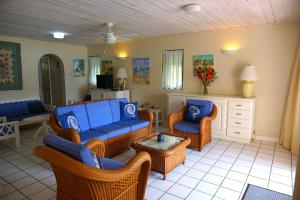 a living room with couches and chairs and a table at Admiral's Quay #5 - Comfortable Townhouse townhouse in Rodney Bay Village