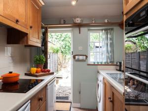 a kitchen with a stove top oven next to a window at 1 bed property in Northiam BT033 in Northiam