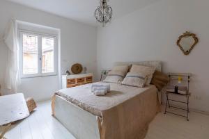 a bedroom with a large bed and a window at Pozzo Garitta, Borgo dei ceramisti, Albissola Marina in Albissola Marina