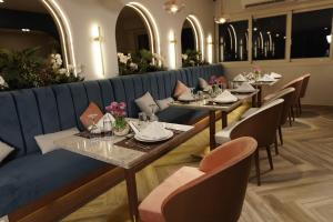 a row of tables in a restaurant with chairs at The Grand Plaza Hotel Smouha in Alexandria +77 photos