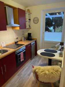 a kitchen with a table and a sink and a stove at Ferienwohnung Leevke in Emden