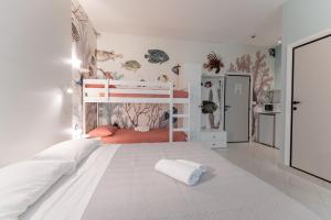 a bedroom with a large bed with a white bedspread at Camping Villaggio Calypso in Cupra Marittima