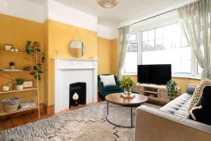 a living room with a couch and a fire place at House in Windsor hosted by Nicola in Windsor