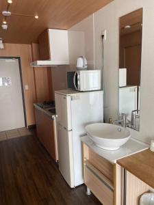 Η κουζίνα ή μικρή κουζίνα στο HOTEL Progress inn 名護 MATABee