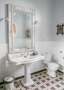 a white bathroom with a sink and a toilet at La Petite Calanque in Marseille +30 photos
