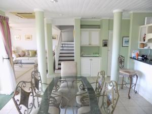 a living room with a glass table and chairs at The Pelican #3 - Spacious 2 bedroom 2,5 bath waterfront townhome in the heart of Rodney Bay, townhouse in Rodney Bay Village