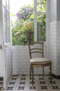 an old chair sitting in front of a window at La Petite Calanque in Marseille