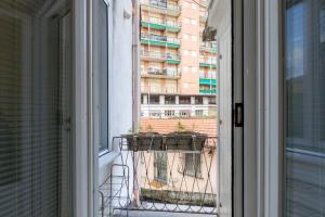 a window with a view of a building at Pozzo Garitta, Borgo dei ceramisti, Albissola Marina in Albissola Marina