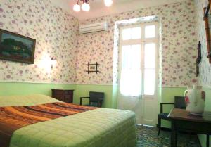 a bedroom with a bed and a window and a desk at La Petite Calanque in Marseille